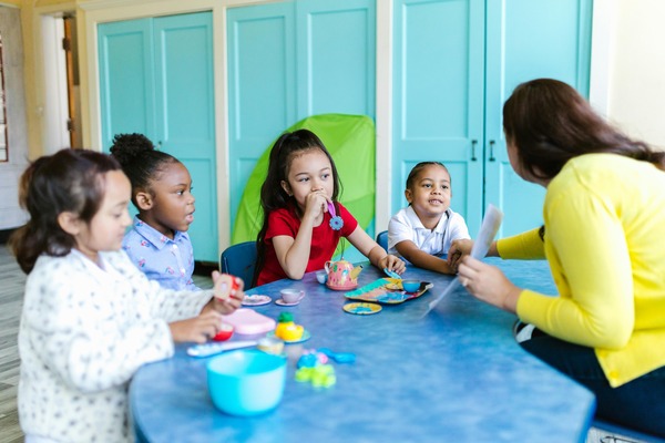Group of toddlers collaboratively playing with colorful building blocks, developing fine motor skills and creativity at Quokka Kids