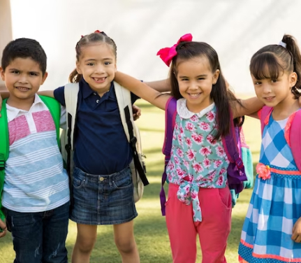 Dedicated preschool teacher reading an engaging storybook to a group of attentive children during Creative Curriculum time at Quokka Kids